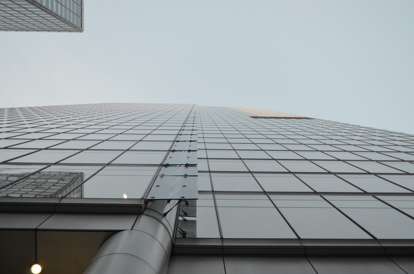 A view straight up the glass facade of a skyscraper