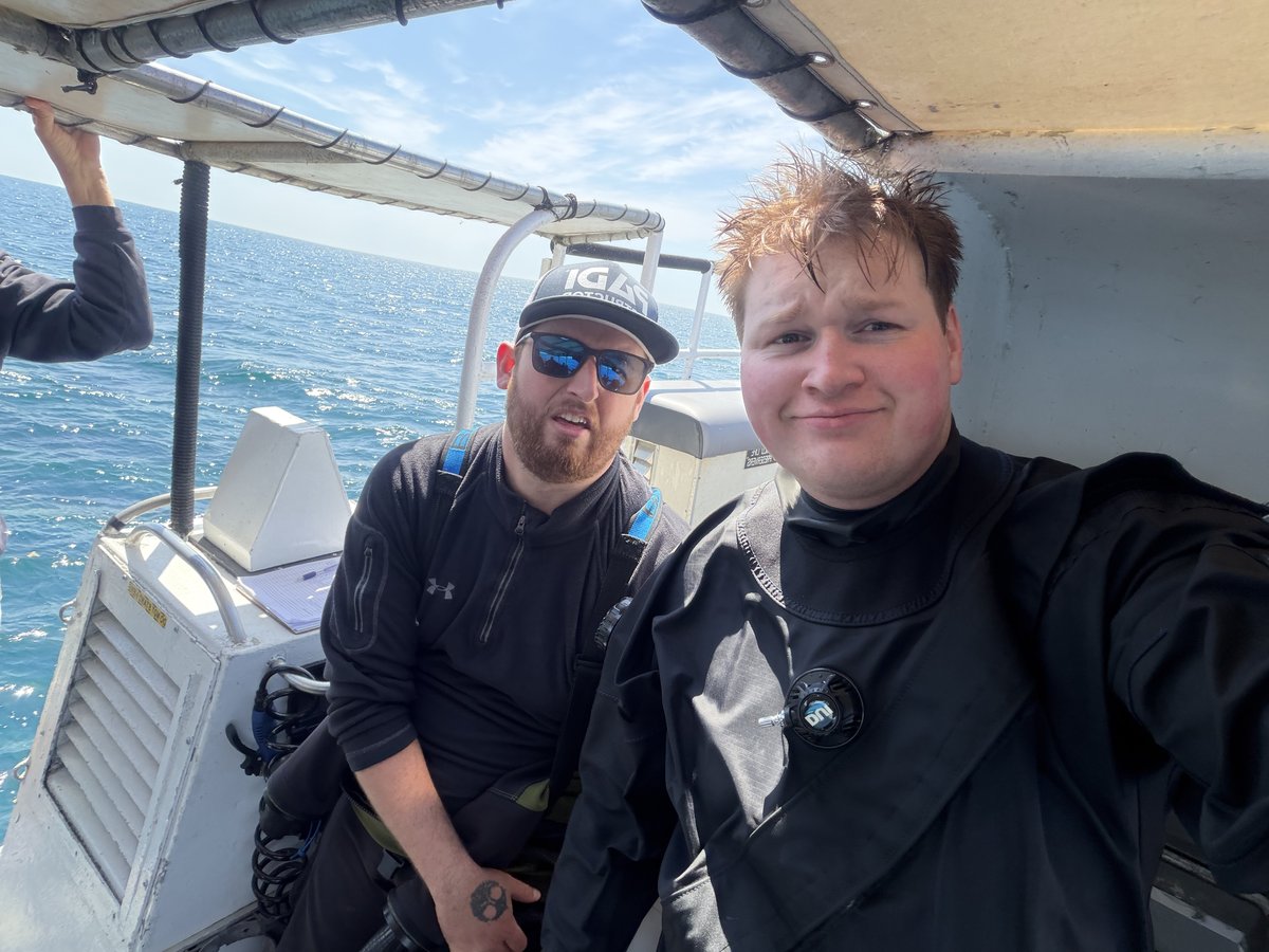 Kian and another diver on a dive boat before a dive