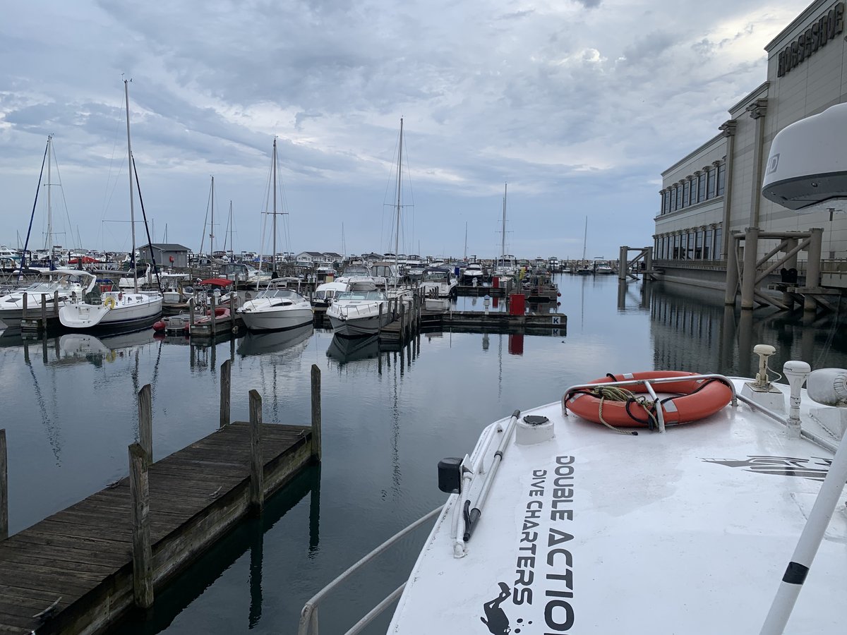 The Double Action Dive Charters boat docked in a marina